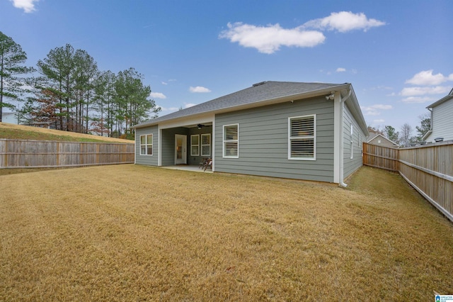 rear view of property featuring ceiling fan and a patio area