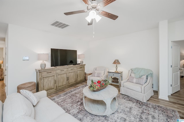 living room featuring ceiling fan and light hardwood / wood-style floors