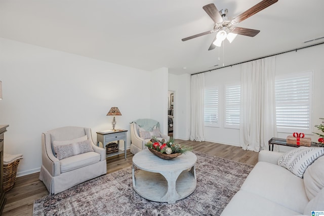 living room featuring hardwood / wood-style flooring and ceiling fan