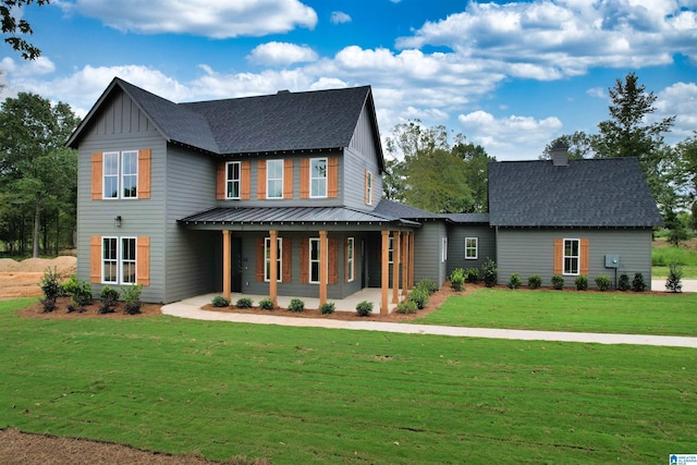 view of front of property with covered porch and a front lawn