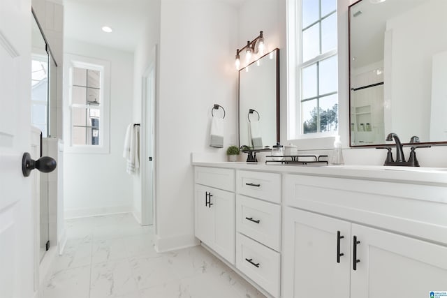 bathroom with vanity and a shower with door