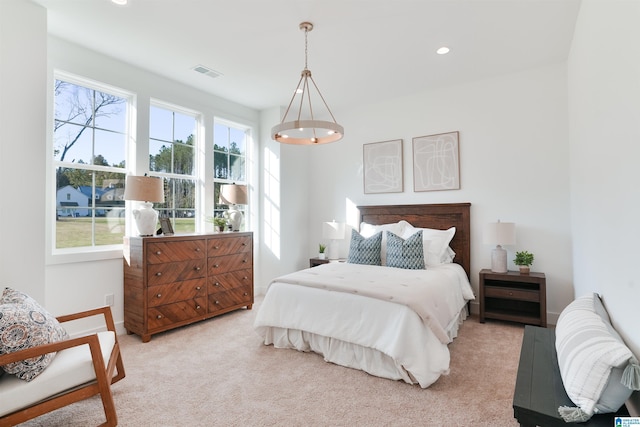 bedroom featuring multiple windows and light colored carpet