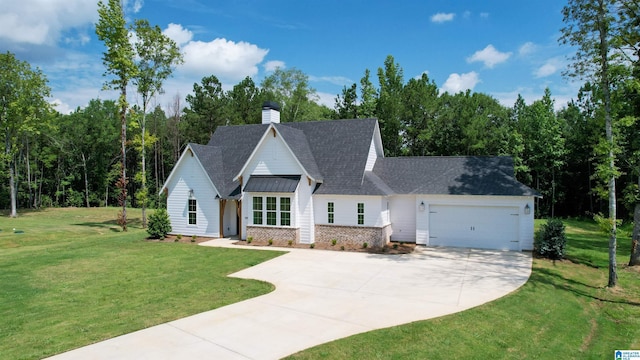 view of front of property with a garage and a front lawn