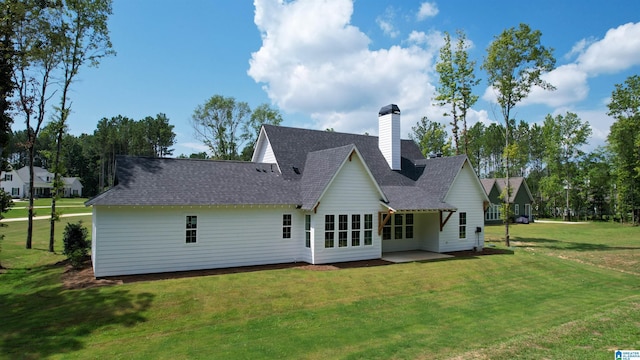 back of house featuring a lawn and a patio area