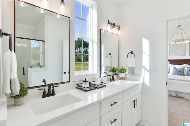 bathroom with vanity, an enclosed shower, and a healthy amount of sunlight