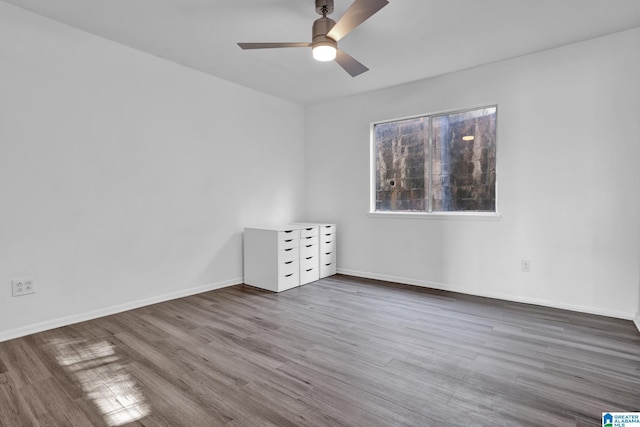 empty room featuring dark hardwood / wood-style floors and ceiling fan