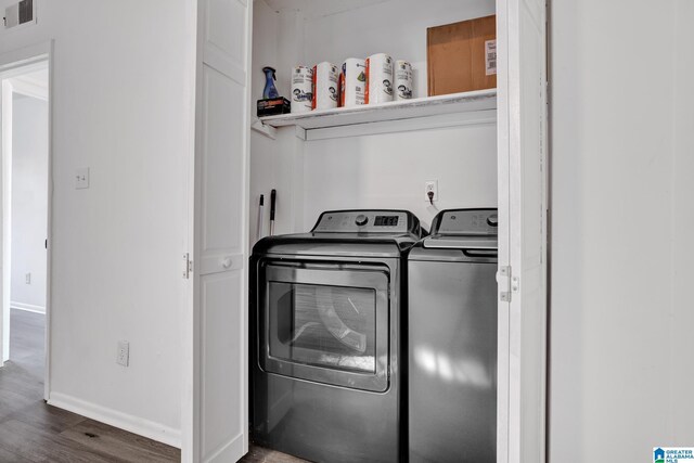 laundry area featuring washer and dryer and dark hardwood / wood-style floors