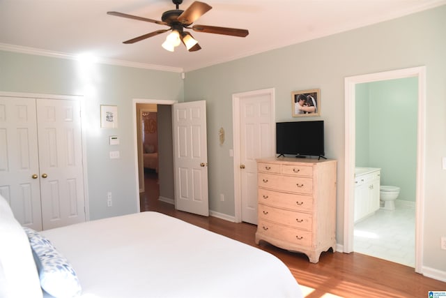 bedroom with connected bathroom, ceiling fan, dark hardwood / wood-style flooring, and ornamental molding