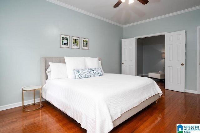 bedroom with ceiling fan, dark hardwood / wood-style flooring, and ornamental molding