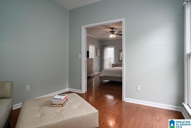 interior space featuring ceiling fan, crown molding, and hardwood / wood-style flooring