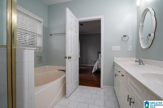 bathroom with tile patterned flooring, vanity, and a tub to relax in