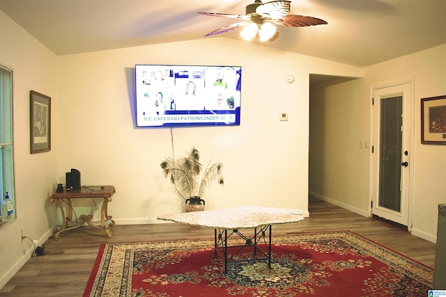 living area featuring ceiling fan, dark hardwood / wood-style floors, and lofted ceiling