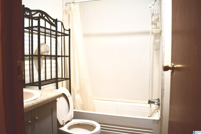 full bathroom with vanity, toilet, and shower / bath combo with shower curtain