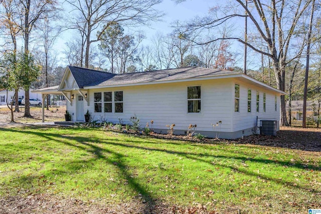 view of front facade with a front yard and central air condition unit