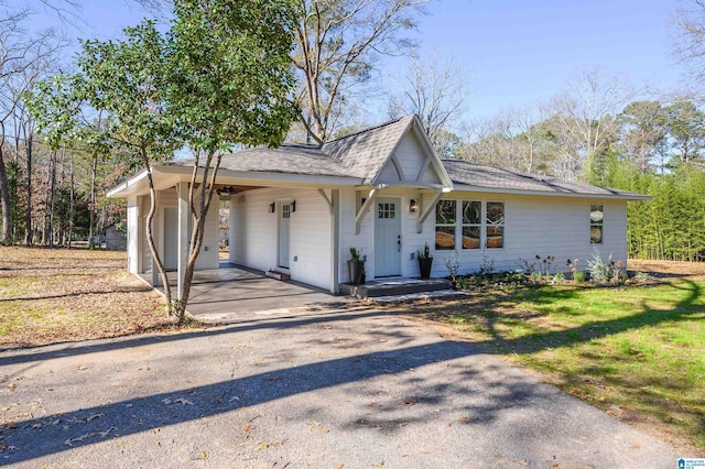 view of front of house with a front yard and a carport