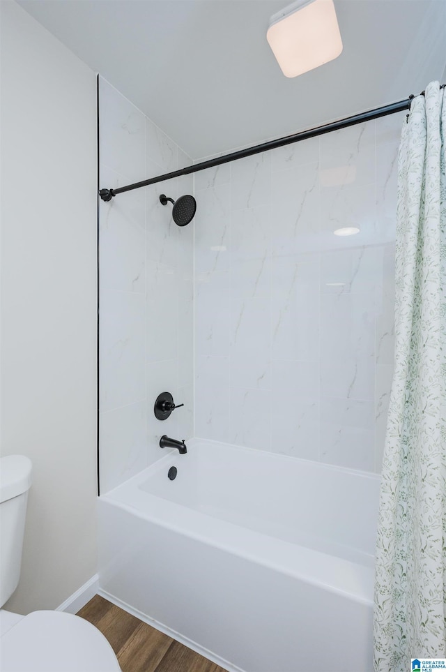 bathroom featuring shower / bath combo with shower curtain, toilet, and wood-type flooring