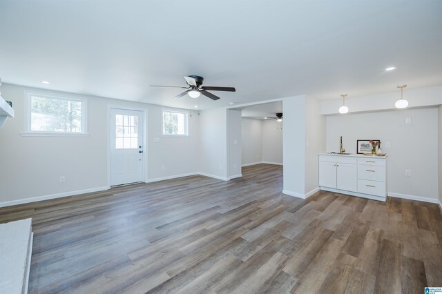 unfurnished living room with light hardwood / wood-style floors and ceiling fan