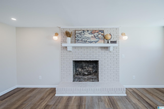 room details featuring a fireplace and hardwood / wood-style flooring