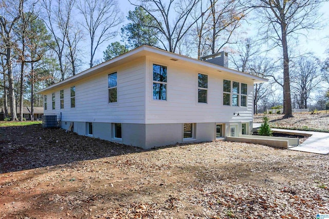 view of side of home with central AC