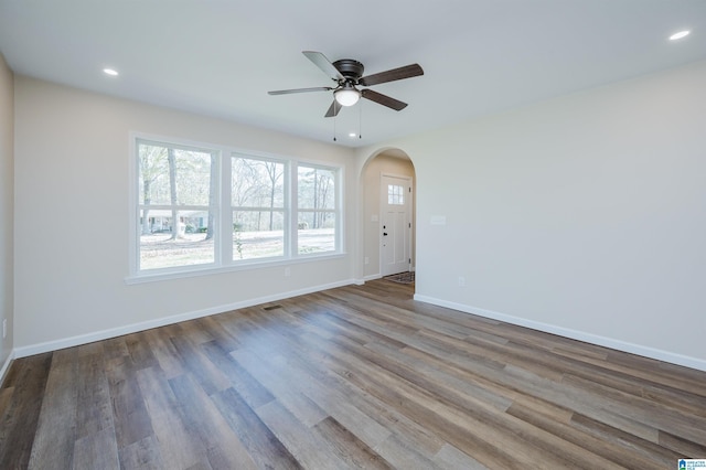 empty room featuring hardwood / wood-style floors and ceiling fan