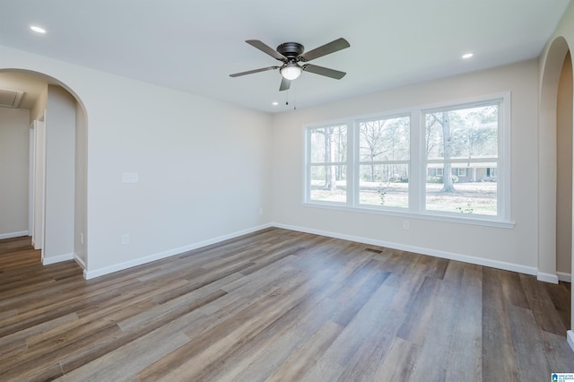 empty room with wood-type flooring and ceiling fan