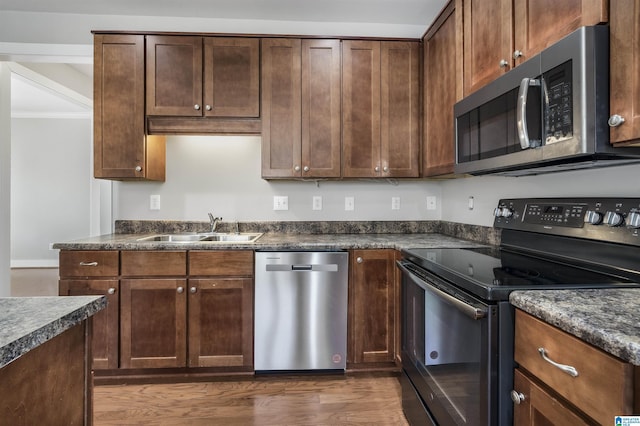 kitchen featuring dark hardwood / wood-style floors, sink, and stainless steel appliances