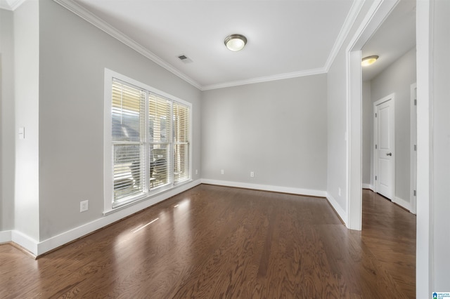 unfurnished room with ornamental molding and dark wood-type flooring