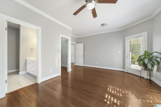 unfurnished bedroom featuring access to exterior, ensuite bath, ceiling fan, crown molding, and a spacious closet