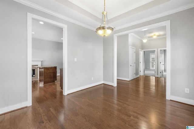 spare room featuring crown molding and dark wood-type flooring