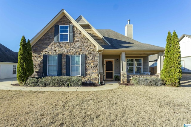 view of front of property featuring covered porch and a front lawn