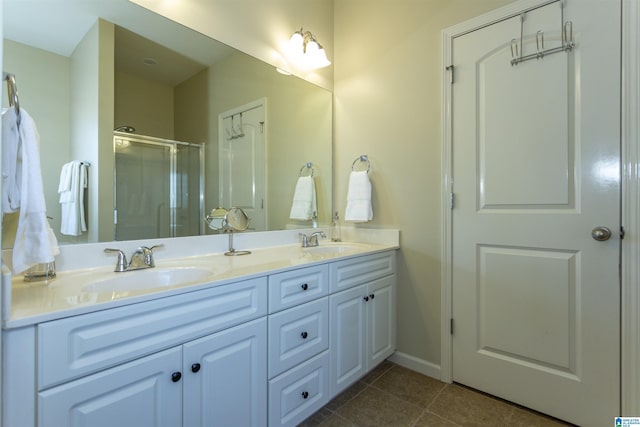 bathroom featuring tile patterned flooring, vanity, and a shower with shower door