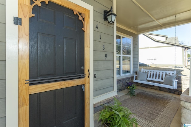 view of exterior entry featuring a porch