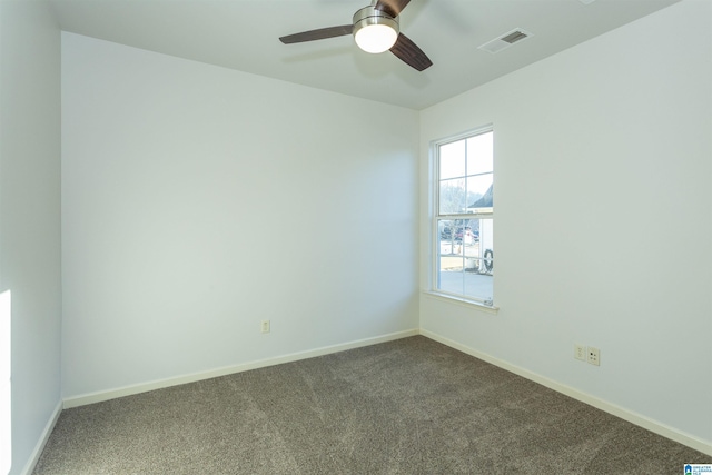 empty room with ceiling fan and carpet floors