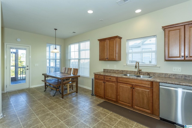 kitchen with decorative light fixtures, stainless steel dishwasher, and sink