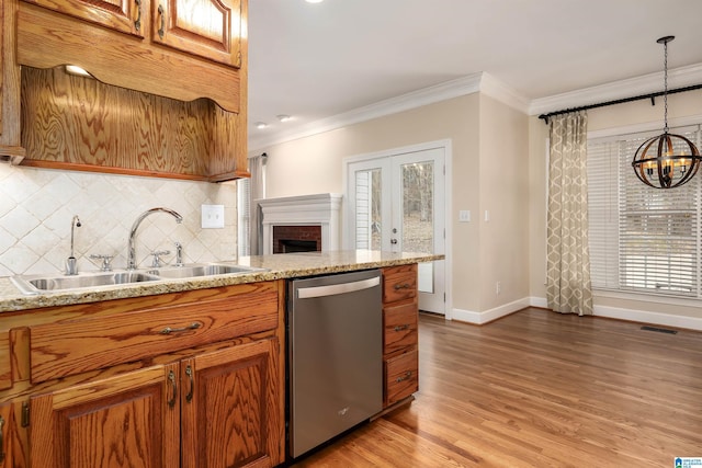 kitchen featuring dishwasher, crown molding, sink, decorative backsplash, and decorative light fixtures