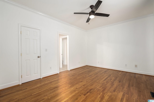 unfurnished room with ceiling fan, dark hardwood / wood-style flooring, and crown molding