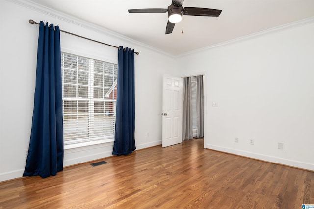 spare room with hardwood / wood-style floors, ceiling fan, and crown molding