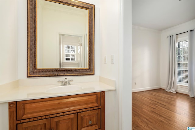 bathroom featuring hardwood / wood-style floors, vanity, and crown molding