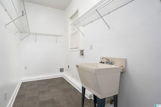 clothes washing area featuring washer hookup, electric dryer hookup, and sink