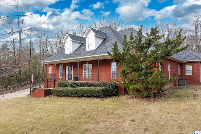 cape cod house with cooling unit, covered porch, and a front lawn