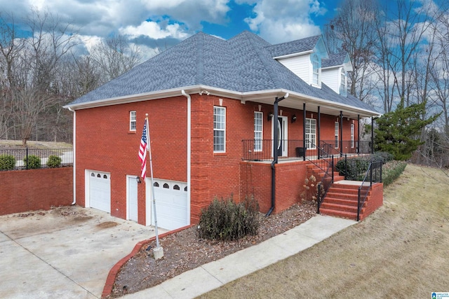 view of side of property with covered porch and a garage