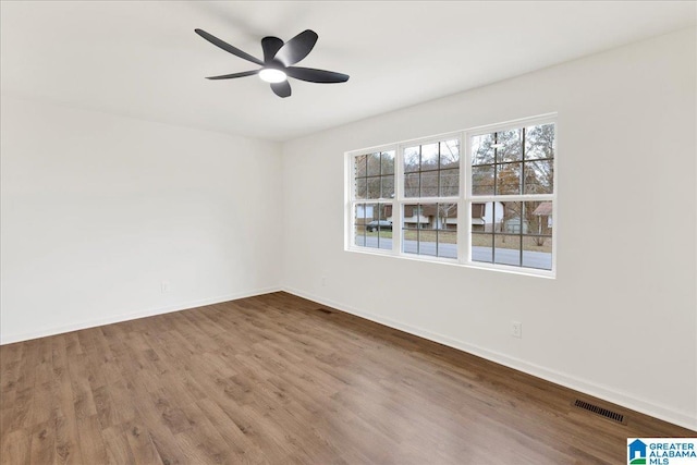 empty room with hardwood / wood-style flooring and ceiling fan