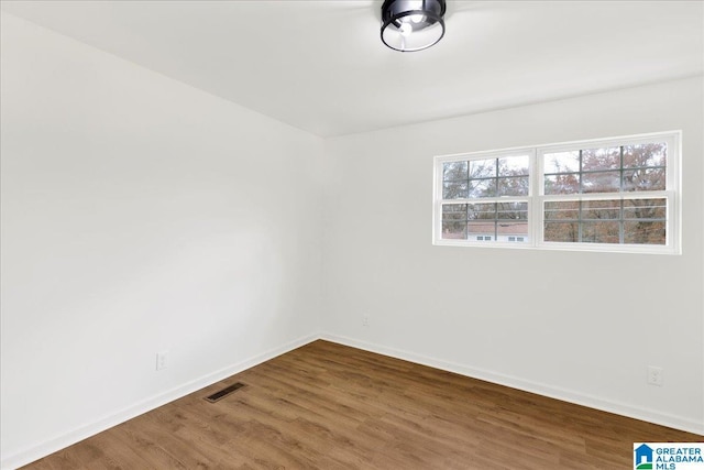 empty room with hardwood / wood-style flooring