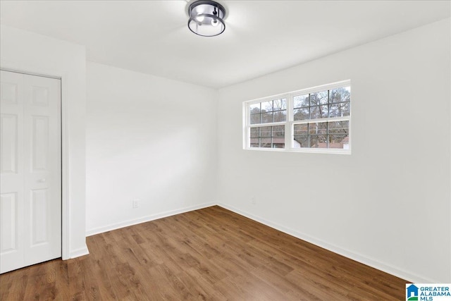 unfurnished room with wood-type flooring