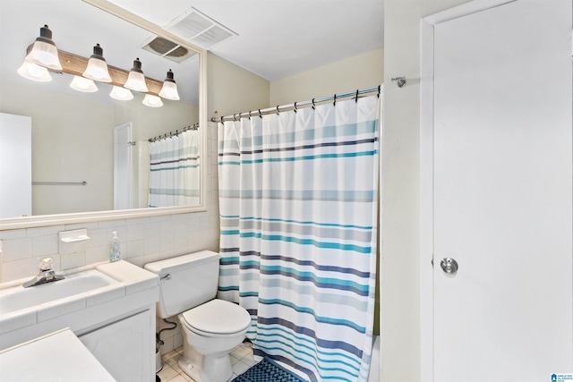 bathroom featuring a shower with curtain, vanity, tile walls, tile patterned flooring, and toilet