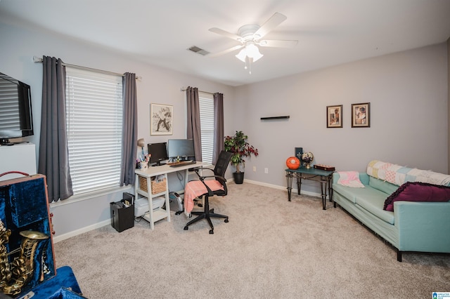 carpeted home office featuring ceiling fan and plenty of natural light