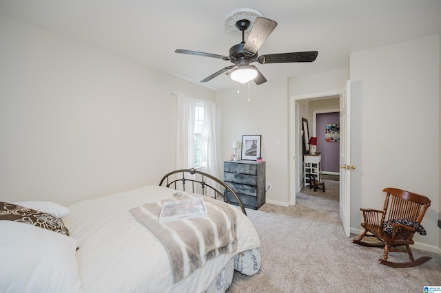 bedroom with ceiling fan and light carpet