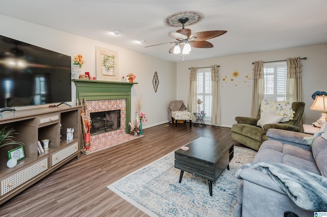 living room featuring a fireplace, ceiling fan, and hardwood / wood-style floors