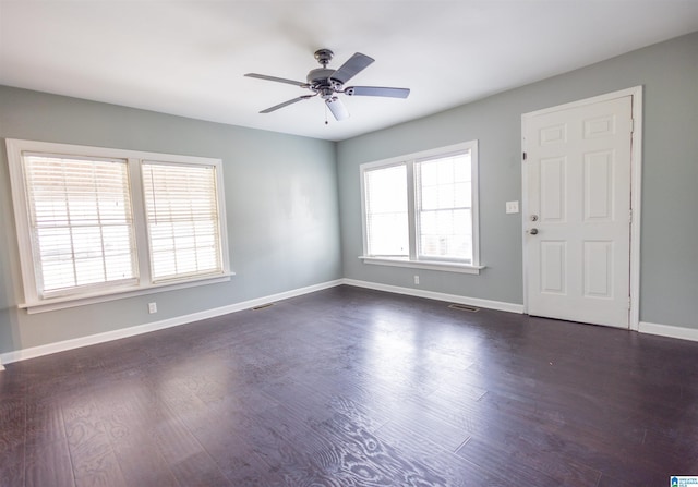 unfurnished room with dark hardwood / wood-style floors and ceiling fan