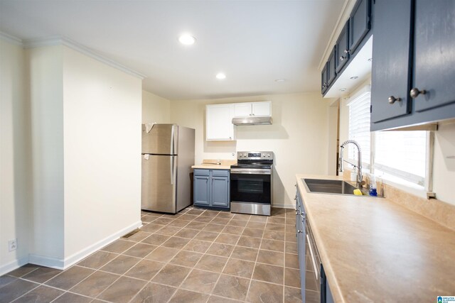 kitchen featuring appliances with stainless steel finishes, sink, blue cabinetry, light tile patterned floors, and white cabinets